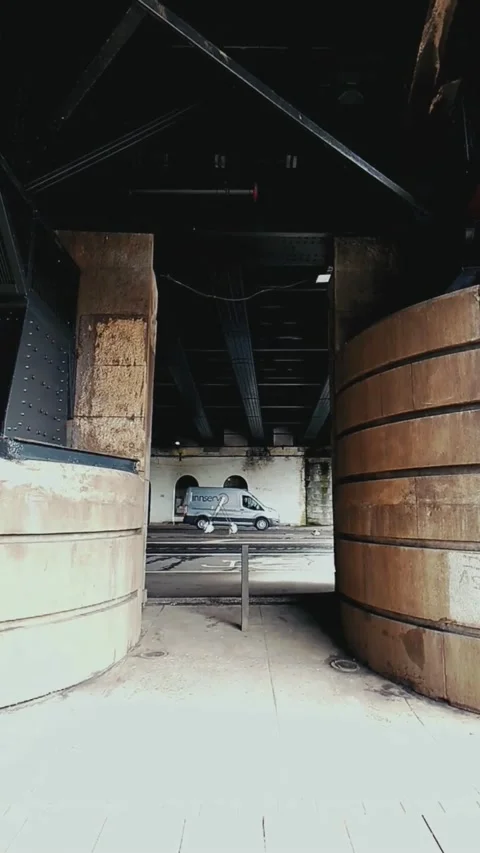 Cars passing between two bridge pillars - Vertical Video Stock Footage 200401059