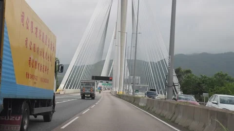 Cars passing Cable-stayed Ting Kau Bridge that spans from the north Stock Footage 158097644