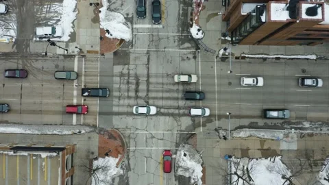 Cars Passing through Intersection of Old Worn Down Road. Top Down Aerial Stock Footage 153064348