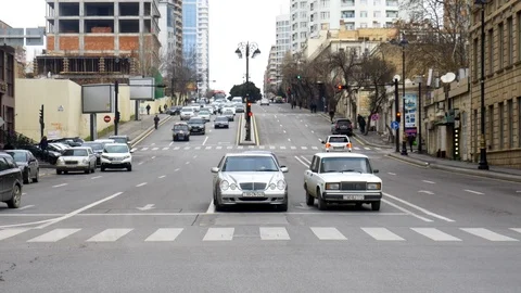 Cars passing through traffic intersection with crosswalk, locked off Stock Footage 109184470