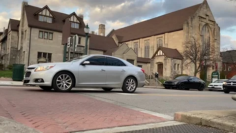 Cars Pulling Up to Stop Sign in Front of Big Church Stock Footage 235082329