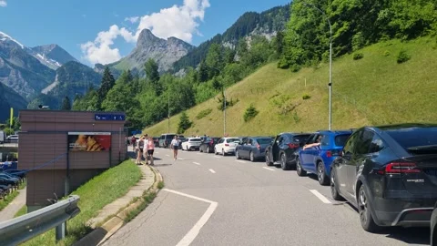 Cars queue at the Lötschberg Autoverlad for the alpine transport train to Stock Footage 340188904