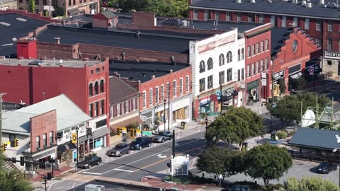 Cars queue at traffic light along historic Lynchburg downtown street, brick Video stock 345727743