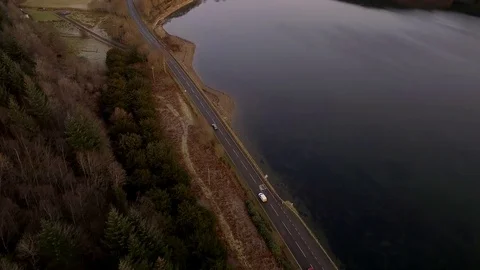 Cars on a Road Surrounding a Loch in Scotland and Landscape Stock Footage