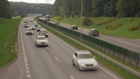 Cars running on highway down street. Four lanes two direction. Vilnius transport Stock Footage