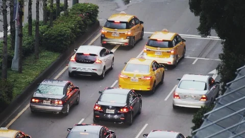 Cars slowly moving through an intersection during an evening rush hour Stock Footage 107036792