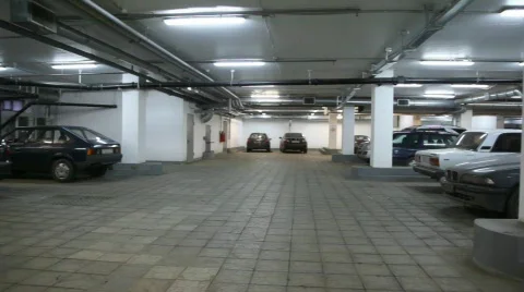 Cars standing in underground car park, panning Stock Footage