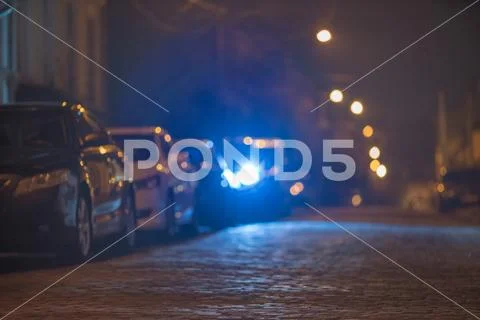 The cars on the stone road. Evening night time. Telephoto lens shot Stock Photos