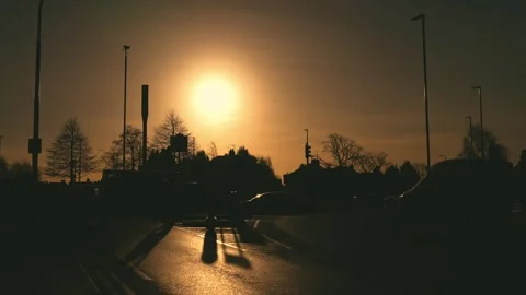 Cars stopping at intersection while pedestrian silhouette crossing wet Stock Footage 306015285