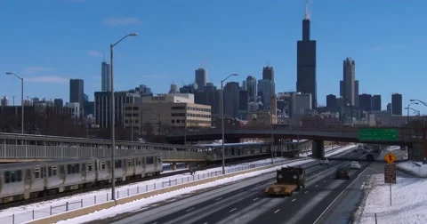 Cars travel on a freeway into Chicago in winter. Stock Footage