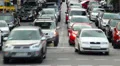 Cars turn left right, stop, people walk on crossroad daytime HD Footage
