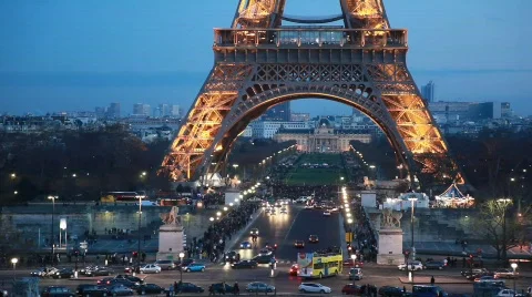 Cars under Eiffel Tower with illumination in night Paris, France. Stock Footage