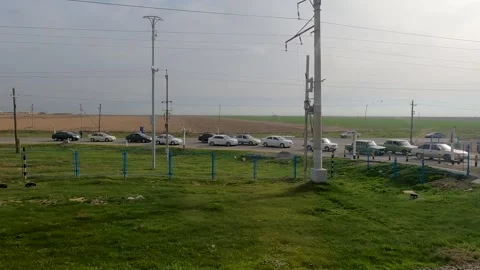 Cars waiting in queue at a railway train crossing in Uzbekistan Central Asia Stock Footage 247999472