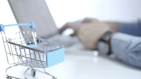 Cart and blurry a man using laptop for shopping online with credit card Stock Footage 129223271