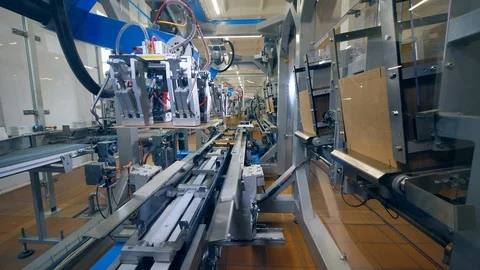 Carton boxes are getting made and relocated by the machine Stock Footage 115107041