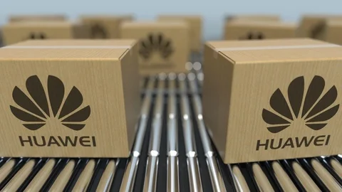 Carton boxes with Huawei logo move on roller conveyor. Conceptual editorial Video stock 108780488