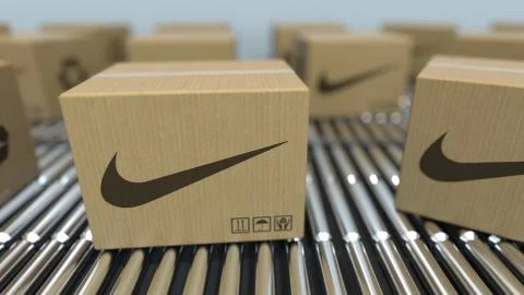 Carton boxes with NIKE logo move on roller conveyor. Realistic 3D rendering Stock Illustration