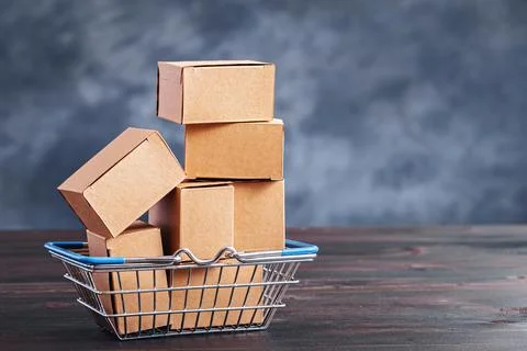 Carton boxes in shopping basket with copy space Stockfoto's