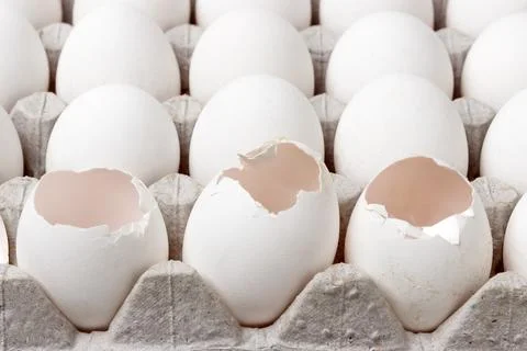 Carton of eggs frontal view. broken egg in package Stock Photos
