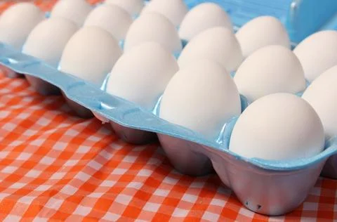 Carton of Eggs on Rustic Table With Checkered Table Cloth Stock Photos