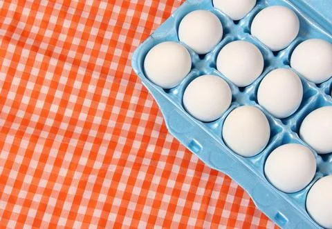 Carton of Eggs on Rustic Table With Checkered Table Cloth Stock Photos