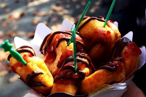 Carton of mini donuts glazed with raspberry sweetness and chocolate glaze Stock Photos