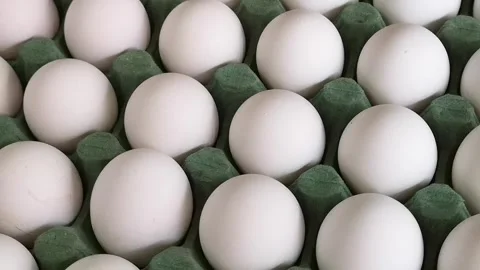 Carton of white eggs rotating closeup Stock Footage 241013109