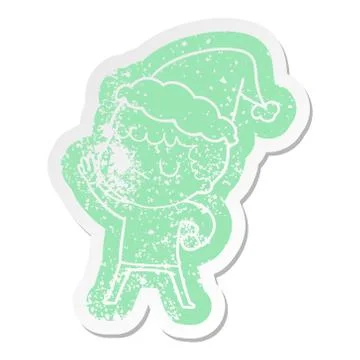 Cartoon distressed sticker of a grumpy boy wearing santa hat Illustrazione stock