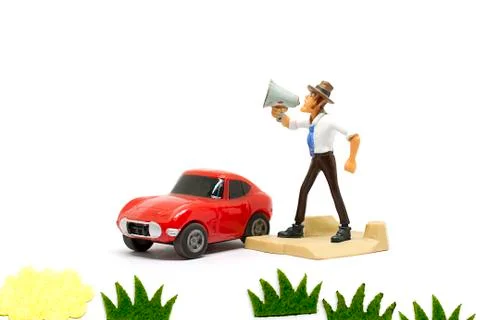 Cartoon doll standing shouting using a megaphone. Stock Photos