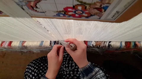 Cartoon pattern design of Persian Carpet rug in Iran and a woman is making Stock Footage 250064502