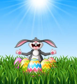 Cartoon rabbit laughing with easter eggs in the grass Stock Illustration
