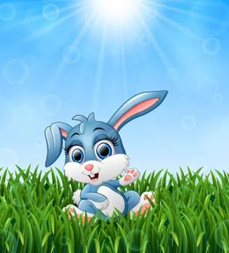 Cartoon rabbit sitting in the grass on a background of bright sunshine Stock Illustration