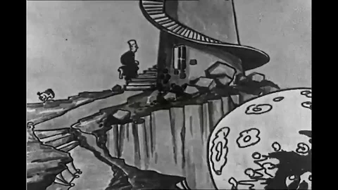 A cartoon sailor jumps on a shell fired from a battleship and rides it to the Stock Footage 116495991
