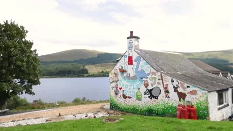 Cartoons drawn on a cottage wall, Scotland, UK Stock Footage 202345053