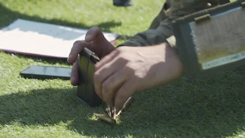 The cartridges are inserted into the clip at speed. close-up Video stock 243483600