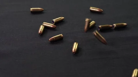 Cartridges fall on a black surface Stock Footage 281105833