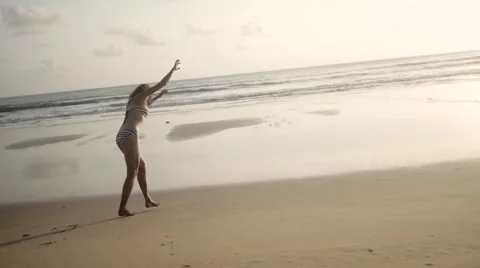 Cartwheel in slow motion by ocean Stock Footage 61140046