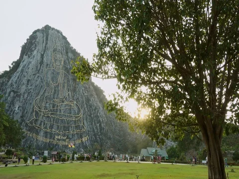 Carved buddha image from gold on the cliff at Khao Chee chan, Pattaya, Thailand Stock Footage 77326175