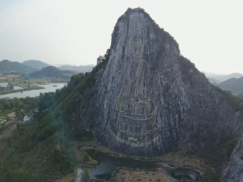 Carved buddha image from gold on the cliff at Khao Chee chan, Pattaya, Thailand Stock Footage 77326244