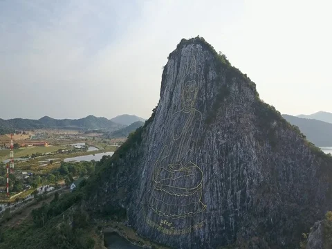 Carved buddha image from gold on the cliff at Khao Chee chan, Pattaya, Thailand Stock Footage 77326251