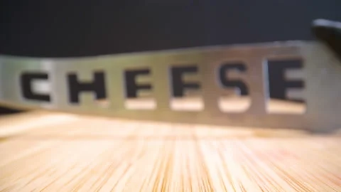 Carved cheese name on the sharp knife Stock Footage 138536757