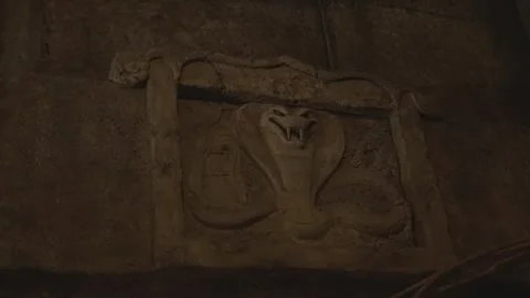 Carved cobra on wall red light up eyes Stock Footage 241942202