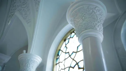 Carved elements on white columns inside white temple. Scene. Carvings on walls Stock Footage 241351295
