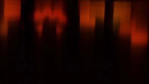 Carved Halloween pumpkin lights inside with flame on a black background with Stock Footage