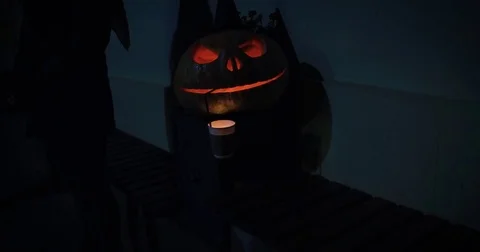 Carved Halloween pumpkin lights inside with flame on a black background Vídeos de archivo 79958470