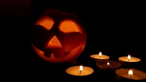 Carved Halloween pumpkins inside a burning fire. Black background. Stock Footage 116153064