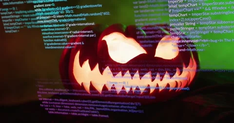 Carved jack-o'-lantern glowing and flickering as code overlay scrolling Stock Footage 317834673