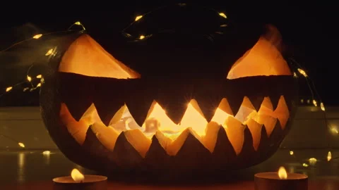 Carved Jack-O-Lantern With Lit Candles Stock Footage 266782497