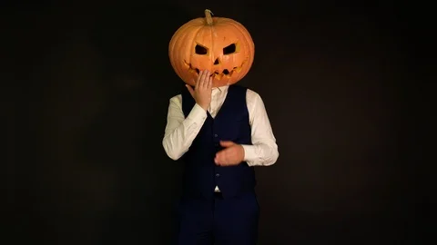 Carved pumpkin. a pumpkin-headed man sends and catches a kiss. Halloween concept Stock Footage 116233196