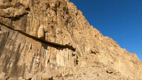 Carved into the side of Kuh-e Bisotun (Mt Bisotun) is a series of bas-reliefs Stock Footage 276505446